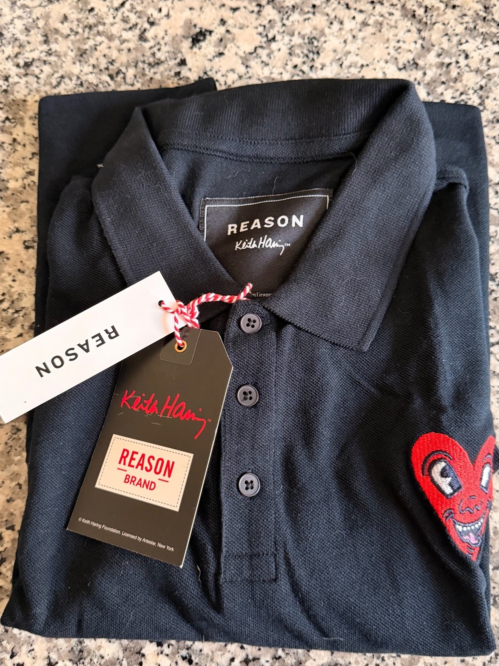 Reason Men’s Black Polo with Red Heart Patch